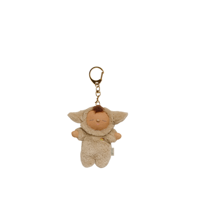 Plush keychain of a baby character with a gold ring on a white background