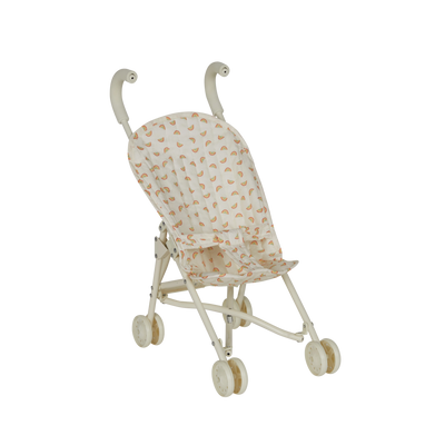 Miniature stroller with a patterned cover on a white background