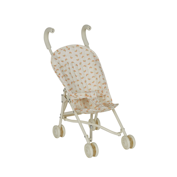 Miniature stroller with a patterned cover on a white background