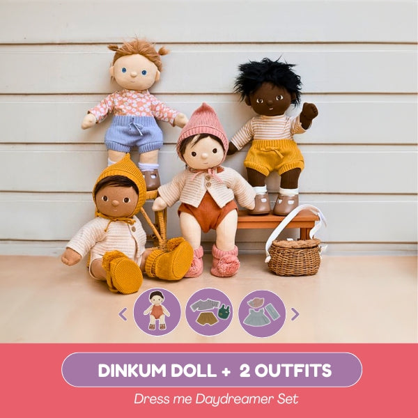 Four dolls with different outfits on a wooden surface, with a pink banner at the bottom.