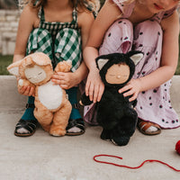 2 little girls playing with a black cat, soft plush toy for kids