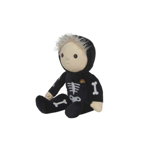 Stuffed toy in a black skeleton outfit with bones and a rainbow on a white background