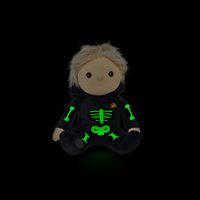 Plush toy with a black hoodie featuring green skeleton designs on a black background