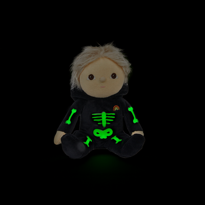 Plush toy with a black hoodie featuring green skeleton designs on a black background