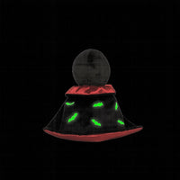 Black and red hat with green glowing eyes on a black background