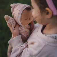 Pink, easter-themed plush doll, perfectly weighted and posable for imaginative doll play. Sodt and cuddly plush doll, an ideal companion from birth.