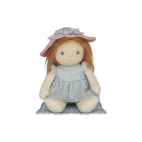 Stuffed doll with red hair, blue eyes, and a pink hat on a white background