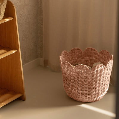 Handwoven rattan storage basket with scalloped edges. Perfect for storing toys, dolls, linen and laundry in your nursery or home. 