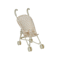 Miniature stroller with a patterned cover on a white background