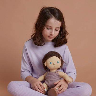 Gender-neutral, posable kids doll with brown hair and removable purple outfit. Dress them up and style their hair for hours of interactive kids play.