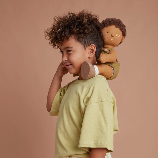 Brown afro haired, posable doll for kids. Snuggle them, dress them up and style their hair. Each Doll comes with its own removable gender-neutral outfit, socks, nappy, and shoes, perfect for interactive doll play.