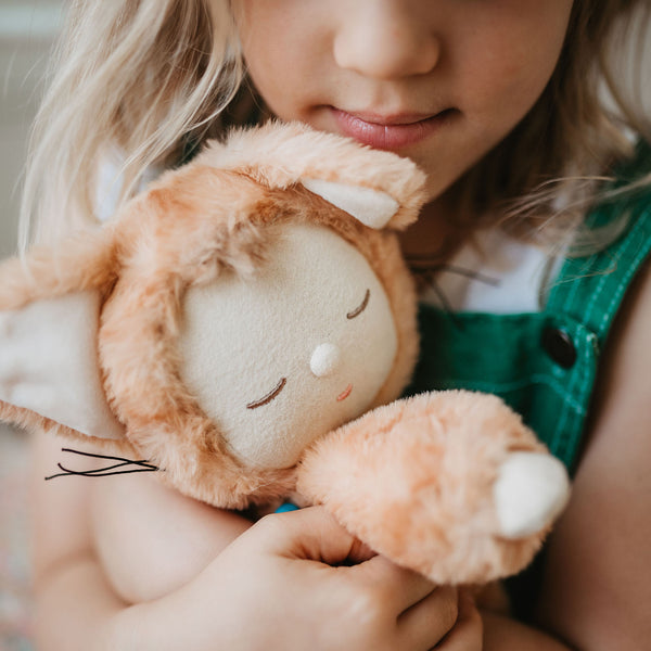 Little girl play with ginger tabby cat, soft plush toy doll for kids