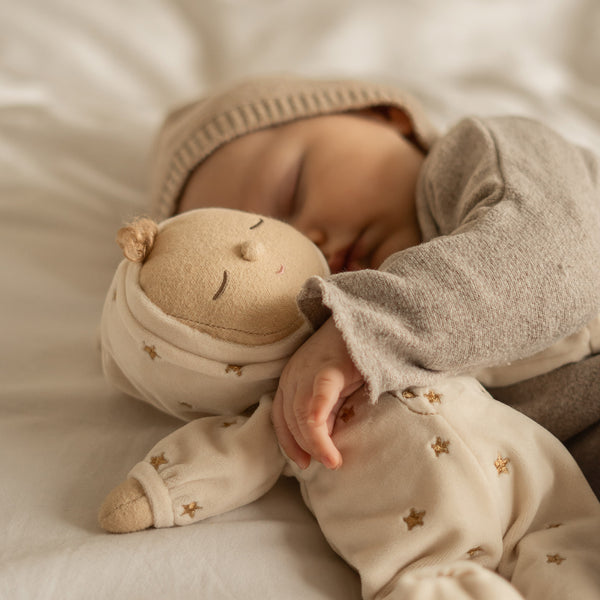 Posable plush doll suitable from birth. The Lullaby Lyra includes a pompom on their bonnet that plays a sleepy tune when pulled. 