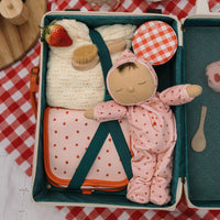 Soft-doll suitable from birth with pink strawberry printed onesie. matching wash bag and suitcase for kids doll play.