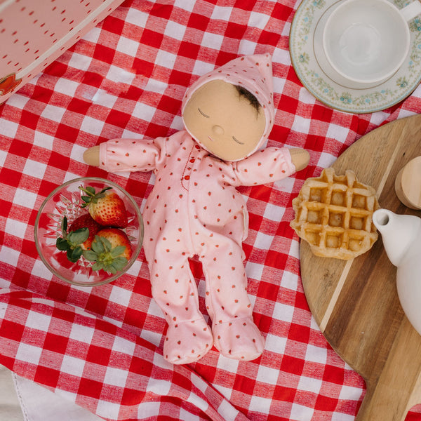 Olli Ella Dozy Dinkum Doll - strawberry. Floppy soft-doll suitable with pink srrawberry printed onesie,