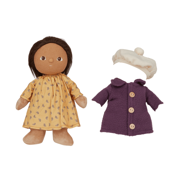 Doll with yellow dress and brown hair, purple coat, and white hat on a white background