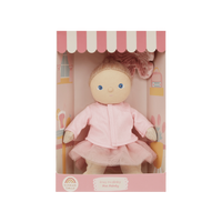 Doll in a pink outfit with a matching box on a white background