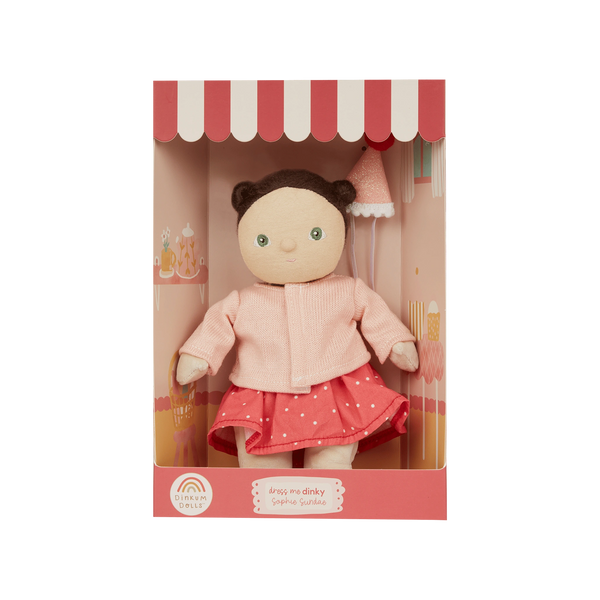 Doll in a pink outfit with a matching box on a white background