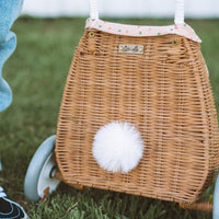 Woven rattan basket on wheels with printed lining. Perfectly sized for your kid to transport their favourite toys, dolls and treasures on their adventures. 