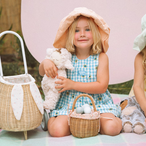 Rattan wheely basket with printed flower lining. Easter themed basket on wheels for kids to transport or store their favourite toys and treasures.