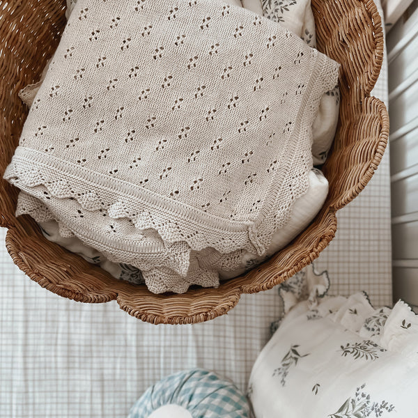 Handwoven rattan storage basket with scalloped edges. Perfect for storing toys, dolls, linen and laundry in your nursery or home. 