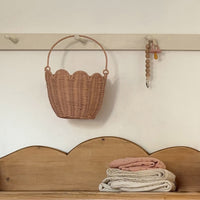 Handwoven pink rattan carry basket, perfect for kids to carry and collect treaures. Fill with dolls and toys, or use as a home décor storage solution in a nursery or bedroom.