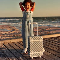 Stylish kids travel suitcase in blue striped design. Perfect for kids' travel, featuring a durable, lightweight build and eco-friendly materials. Made from recycled plastic bottles.