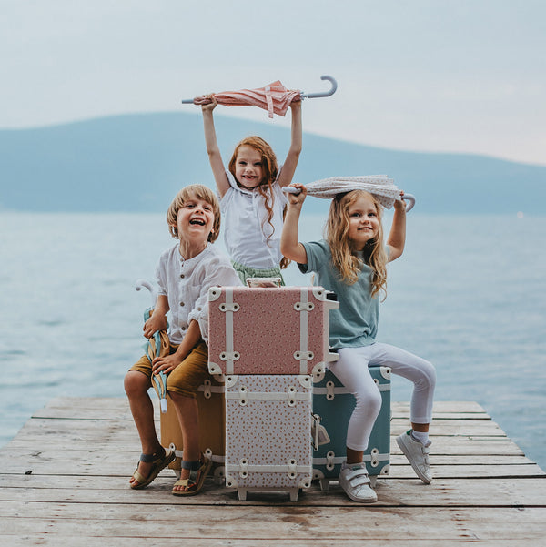 Olli Ella see ya suitcases and umbrellas pictured with children