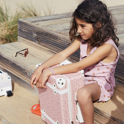 The ultimate kids travel suitcase. Pink daisies print suitcase for kids holidays, with straps to carry their favourite doll / toy.